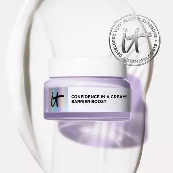 IT Cosmetics Confidence in a Cream Barrier Boost moisturizer jar on cream texture background, developed with dermatologists.