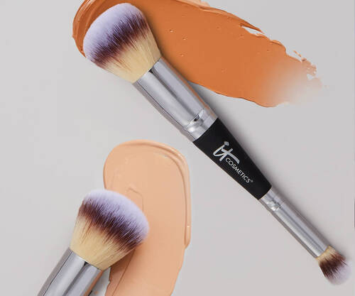 Two ItCosmetics dual-ended foundation brush #7 with a foundation swatch behind each brush.