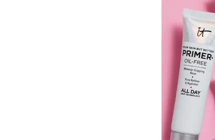 IT Cosmetics Your Skin But Better Oil-Free Primer tube on pink background, designed for pore refining and hydration.