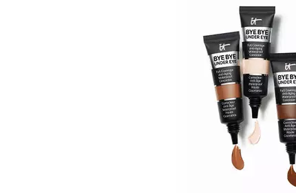 Three tubes of IT Cosmetics Bye Bye Under Eye Full Coverage Concealer in different shades with product swatches.